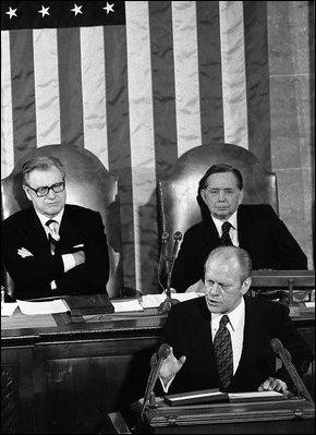 President Gerald R. Ford addresses the nation on the State of the Union, Jan. 15, 1975, from the U.S. Capitol in Washington, D.C. Vice President Nelson Rockefeller, background-left, and House Speaker Carl Albert listen during the address.