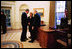 President George W. Bush talks with former President Gerald R. Ford and Betty Ford during a visit to the Oval Office July 16, 2003.