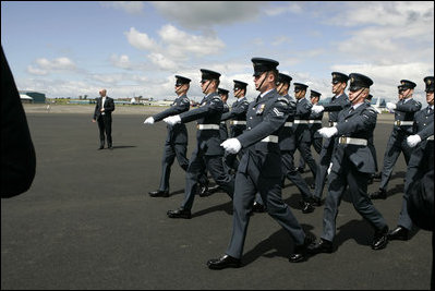 Soldiers parade by President George W. Bush and Laura Bush during an arrival ceremony at Glasgow Prestwick International Airport in Scotland July 6, 2005.