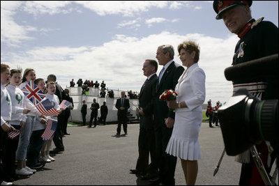 President George W. Bush and Laura Bush are greeted by ceremony and cheers upon their arrival at Glasgow Prestwick International Airport in Scotland July 6, 2005.