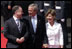 President George W. Bush and Laura Bush walk with Scotland's First Minister Jack McConnell   during the playing of national anthems upon their arrival at Glasgow's Prestiwick Airport, July 6, 2005.