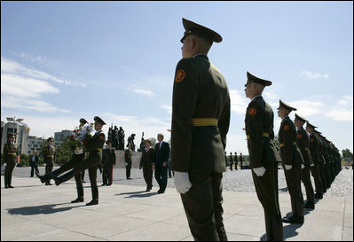 President George W. Bush and Laura Bush follow a Russian honor guard to place a wreath at the Monument to the Heroic Defenders of Leningrad, Friday, July 14, 2006, in St. Petersburg, Russia.