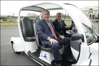 President George W. Bush is escorted by President Vladimir Putin of Russia, as they drive an electric GEM car to the Bilateral Meeting Room at the Konstantinovsky Palace Complex, site of the G8 Summit Saturday, July 15, 2006, in Strelna, Russia.