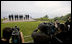 Photographers train their lenses on the G-8 leaders Tuesday, July 8, 2008, as they pose for the official family photograph in Toyako, Japan. In the background is Lake Toya.