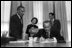 Former First Lady Lady Bird Johnson, center-background, watches as President Lyndon B. Johnson signs the Interior Department Appropriation Bill in the Oval Office Sept. 26, 1968. LBJ Library Photo by Yoichi Okamoto 