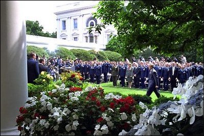 President George W. Bush approached the podium for the presentation ceremony of Commander-in-Chief's Trophy to the Air Force Academy football team in the Rose Garden Friday, May 17, 2002. "I'm proud of what this group of Americans have done on the football field. No more proud than those who wear the blue, I might add. And I'm proud of your commitment to our country," said the President in his address. 