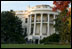 The setting sun paints a Scarlet Oak tree on the White House South Lawn in the rich colors of the 2006 fall season.