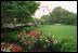 Pictured is the Rose Garden viewed from the West Wing. To the left is the West Colonnade. 