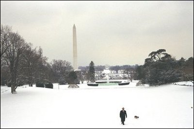 The President takes a walk in the snow on the South Lawn with his dog, Spot, Thursday, Dec. 5, 2002.