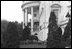 The South Portico is reflected in the surface of the East Garden pond on an overcast day, c. 1910.