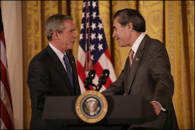 President George W. Bush thanks U.S. Commerce Secretary Carlos Gutierrez for his introduction in the East Room of the White House, Friday, Oct. 7, 2005, as President Bush prepares to address remarks in celebration of Hispanic Heritage Month. President Bush also honored recipients of the President's Volunteer Service Awards at the event.