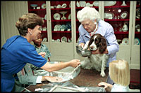 With a curious look, first pet Millie Bush has her paw print made for a greeting card in the China Room on July 2, 1991. Millie's owners were President George H.W. Bush and Barbara Bush. Millie's offspring, Spot, now lives in the White House with President George W. Bush and Laura Bush.