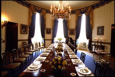 A White House usher prepares the Blue Room for a luncheon for the European Commission May 2, 2002. 