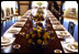 A White House usher prepares the Blue Room for a luncheon for the European Commission May 2, 2002. 