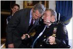 President George W. Bush speaks with NYPD Officer Steve McDonald in the Blue Room April 10, 2002. 