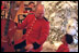 A member of the Marine Band greets a young fan in the Cross Hall during the 2001 holiday season at the White House.