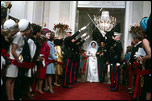 As part of the wedding festivities, President Johnson's daughter, Lynda, and Charles Robb walk under swords into the Cross Hall.