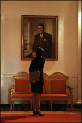 In between meetings, National Security Adviser Condoleezza Rice studies a portrait of President Ronald Reagan in the Cross Hall on Feb. 13, 2002.