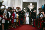 As part of the wedding festivities, President Johnson's daughter, Lynda, and Charles Robb walk under swords into the Cross Hall.