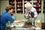 With a curious look, first pet Millie Bush has her paw print made for a greeting card in the China Room on July 2, 1991. Millie's owners were President George H.W. Bush and Barbara Bush. Millie's offspring, Spot, now lives in the White House with President George W. Bush and Laura Bush.