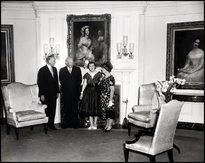 President Dwight Eisenhower and Mamie Eisenhower receive a donation of antique furniture for the Diplomatic Reception Room of the White House on June 29, 1960. The Federal style furniture includes a pale gold silk sofa and matching chairs. Joining the Eiswenhowers are Michael Greer of the National Society of Interior Designers, Inc. and designer Dora Brahms. 