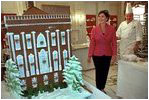 In the China Room, Laura Bush takes a sneak preview at White House Pastry Chef Roland Mesnier's gingerbread creation Dec. 2, 2001. Built from more than 80 pounds of gingerbread, it is a re-creation of the original White House as it appeared in 1800 when John Adams became the first resident. 