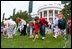 Carrying on a tradition started by President Rutherford B. Hayes in 1878, children roll hard-boiled eggs across the South Lawn during the annual White House Easter Egg Roll Monday, April 21, 2003. In honor of America's service personnel, the festivities this year were open to U.S. military families. 