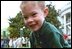 A young competitor shows off his slightly-cracked, but still intact hard-boiled Easter egg after rolling it through the South Lawn race course during the White House Easter Egg Roll Monday, April 21, 2003. 