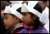 Listening to stories told by authors and Cabinet Secretaries, two young children perk their ears up during story time at the White House Easter Egg Roll Monday, April 21, 2003. 