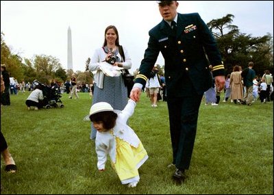 A tiny Easter egg toddler leads the charge at the White House Easter Egg Roll Monday, April 21, 2003. About 12,000 U.S. military families came to the South Lawn to race with Easter Eggs, play games, and listen to children's stories. 