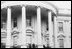 Three years later, in a similar photo, First Lady Lou Hoover waves at the gathering crowd for the White House Easter Egg Roll. President Hoover stands beside her. 