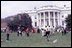 Two kids toss eggs on the South Lawn of the White House at the 1966 Easter Egg Roll. Such Games as "Egg Picking," "Egg Ball," "Toss and Catch," and "Egg Croquet" began near the end of the nineteenth century at the White House Easter Egg Roll.