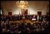 Joined by members of Congress and 15 American families in the East Room June 7, 2001, President George W. Bush signs the Tax Relief Act, which provides Americans with across-the-board tax cuts.