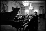 Former President Harry Truman tickles the ivories for President and Mrs. Kennedy in the East Room November 1, 1961.