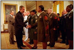 With a portrait of America's first General and first President hanging in the background, President George W. Bush and Defense Secretary Donald Rumsfeld congratulate military re-enlistees in an event held in the East Room May 23, 2001. Congress purchased the portrait of George Washington by Gilbert Stuart for the White House in 1800. 