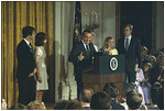 Surrounded by his family and staff, President Richard Nixon says goodbye as he leaves office August 9, 1974.