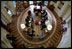 President George W. Bush hosts a meeting with senior advisers in the newly-renovated Oval Office, which includes a specially-designed wool rug featuring the Presidential coat of arms Dec. 20, 2001. The color scheme of the first Oval Office, built in 1909 during the Taft Administration, was olive green. 