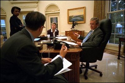 Before his address to Congress and the nation following the attacks of September 11, President George W. Bush meets with speechwriter Michael Gerson, National Security Advisor Condoleezza Rice and Counselor Karen Hughes in the Oval Office Sept. 20, 2001. 