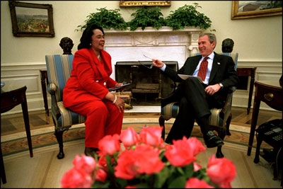 President George W. Bush and Coretta Scott King, the widow of Dr. Martin Luther King, Jr., share a laugh in the Oval Office Jan. 21, 2002. President George W. Bush honored Dr. King in a White House celebration and received a portrait of the civil rights leader from his wife and children in the East Room.