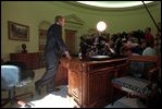 After talking with Governor George Pataki and Mayor Rudolph Giuliani in a televised telephone conversation, President Bush addresses reporters in the Oval Office September 13, 2001.