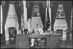 While working at his desk in the Oval Office, which he had moved to its current location in 1934, President Franklin Roosevelt meets with Marguerite Le Hand, his personal secretary.