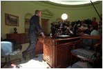 After talking with Governor George Pataki and Mayor Rudolph Giuliani in a televised telephone conversation, President Bush addresses reporters in the Oval Office September 13, 2001.