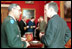 President George H.W. Bush talks with General Colin Powell, during a meeting with the Joint Chiefs of Staff in the Red Room on January 16, 1992. General Powell later served as Secretary of State during President George W. Bush's first term.