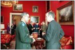 President George H.W. Bush talks with General Colin Powell, during a meeting with the Joint Chiefs of Staff in the Red Room on January 16, 1992. General Powell later served as Secretary of State during President George W. Bush's first term.