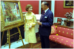 Rosalynn Carter admires a painting in the Red Room with White House Curator Clem Conger September 28, 1977.