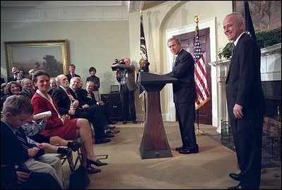 President George W. Bush and Jim Towey pause to smile at Mr. Towey's children during the ceremony in the Roosevelt Room in which the President names him as Director of Faith-Based & Community Initiatives, Feb. 1, 2002. 