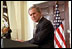 President George W. Bush and Jim Towey pause to smile at Mr. Towey's children during the ceremony in the Roosevelt Room in which the President names him as Director of Faith-Based & Community Initiatives, Feb. 1, 2002. 