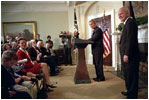 President George W. Bush and Jim Towey pause to smile at Mr. Towey's children during the ceremony in the Roosevelt Room in which the President names him as Director of Faith-Based & Community Initiatives, Feb. 1, 2002.