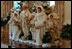 Decorated for the holidays, the State Dining Room showcases custom-made white and gold carolers, Dec. 5, 2001. 