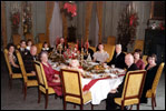 President and Mrs. Eisenhower are all smiles as they host a 1960 Christmas Party in the State Dining Room.